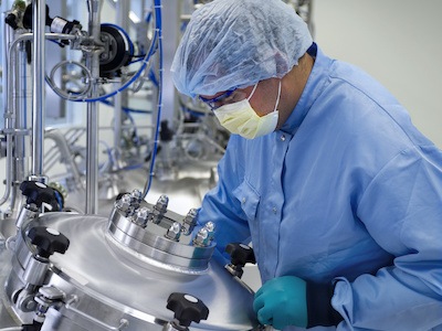 Scientist works at biopharma manufacturing facility