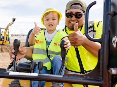 Construction worker and pediatric child participate in the Big Dig for Kids hosted by the Phoenix Children’s Hospital