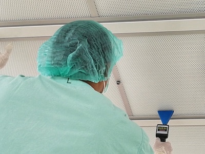 Cleanroom technician performing a HEPA Filter Integrity Test and Airflow Visualization Test