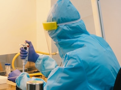 Lab technician performing bio medical research in a cleanroom environment