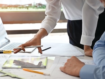 Construction professionals reviewing changes to initial design plans