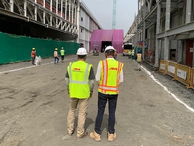 AM employees standing at a job site for the first tool install for a major semiconductor company building