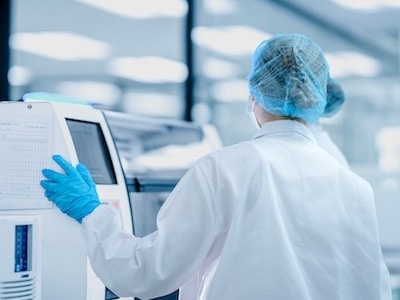 Biotech worker analyzing samples using a biocabinet