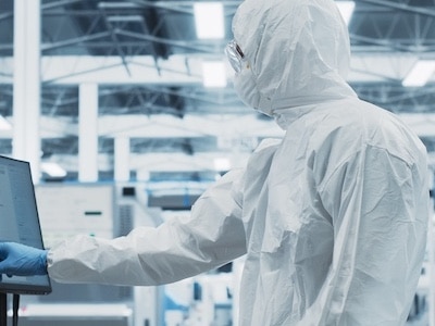 Semiconductor facility production workers perform research in the fab